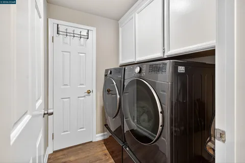a bath room with a toilet a sink and a mirror