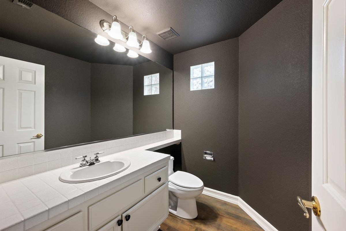 6206 Lakeview Circle San Ramon, CA 94582 - Photo 45 of 57 a bath room with a toilet a sink and a mirror