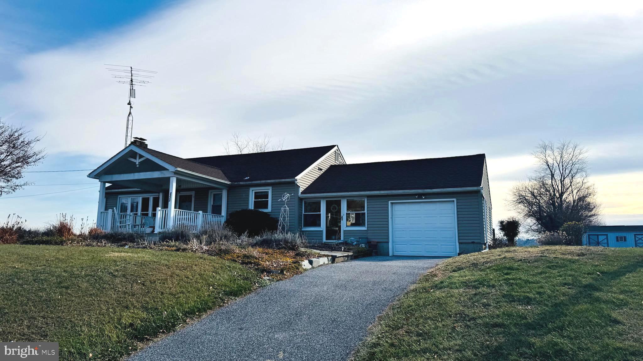 2311 Bachmans Valley Road Manchester, MD 21102 - Photo 2 of 6 a front view of a house with a garden