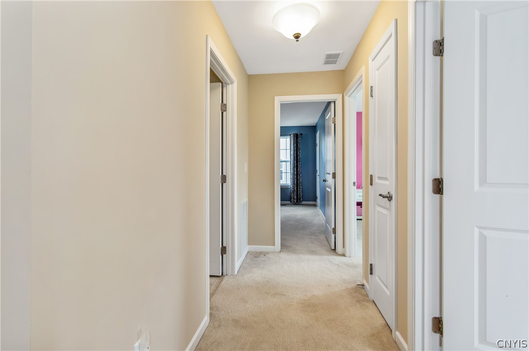 9 Naylor Circle Van Buren, NY 13027 - Photo 19 of 41 Upstairs Hallway: Laundry room on the left with a