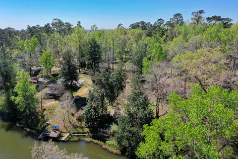 an aerial view of a houses with a yard