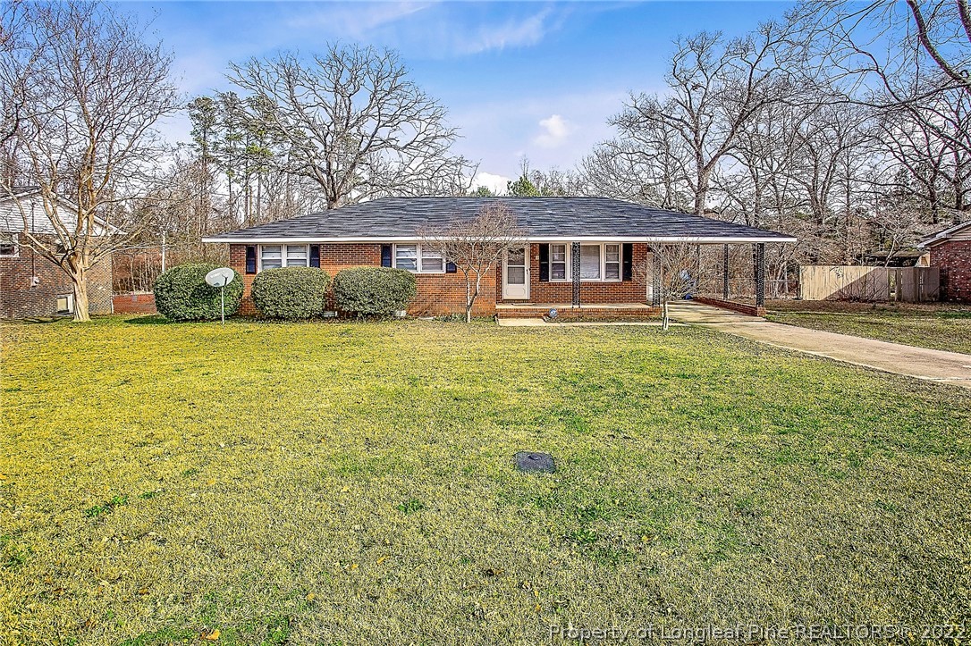 660 Pleasant Loop Fayetteville, NC 28311 - Photo 1 of 35 a front view of a house with a garden
