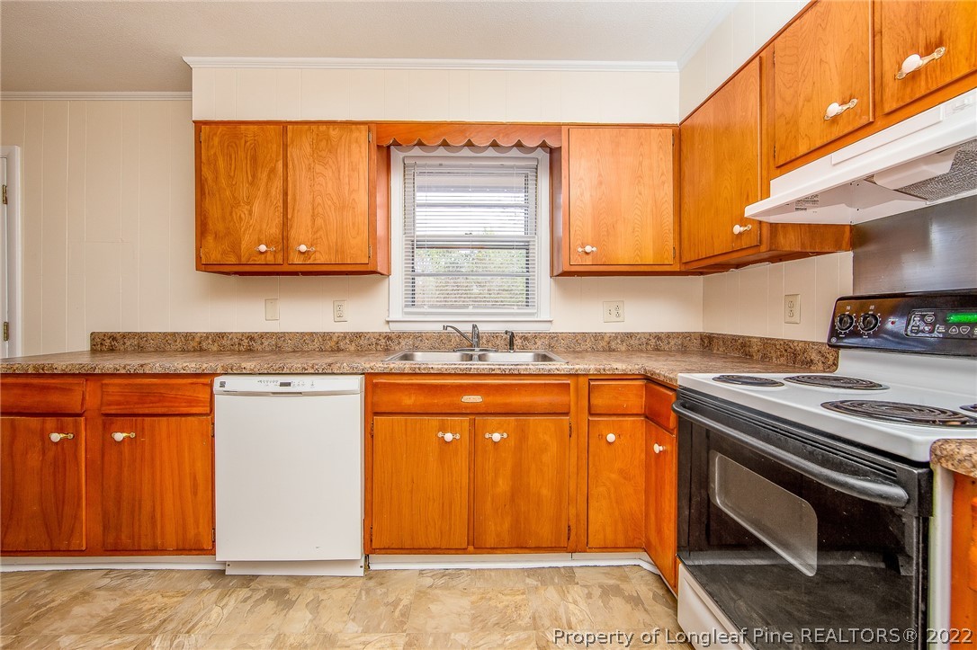 660 Pleasant Loop Fayetteville, NC 28311 - Photo 12 of 35 a kitchen with stainless steel appliances granite countertop a stove a sink and a microwave