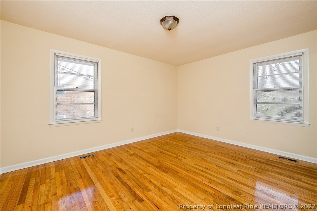 660 Pleasant Loop Fayetteville, NC 28311 - Photo 16 of 35 a view of empty room with window and wooden floor