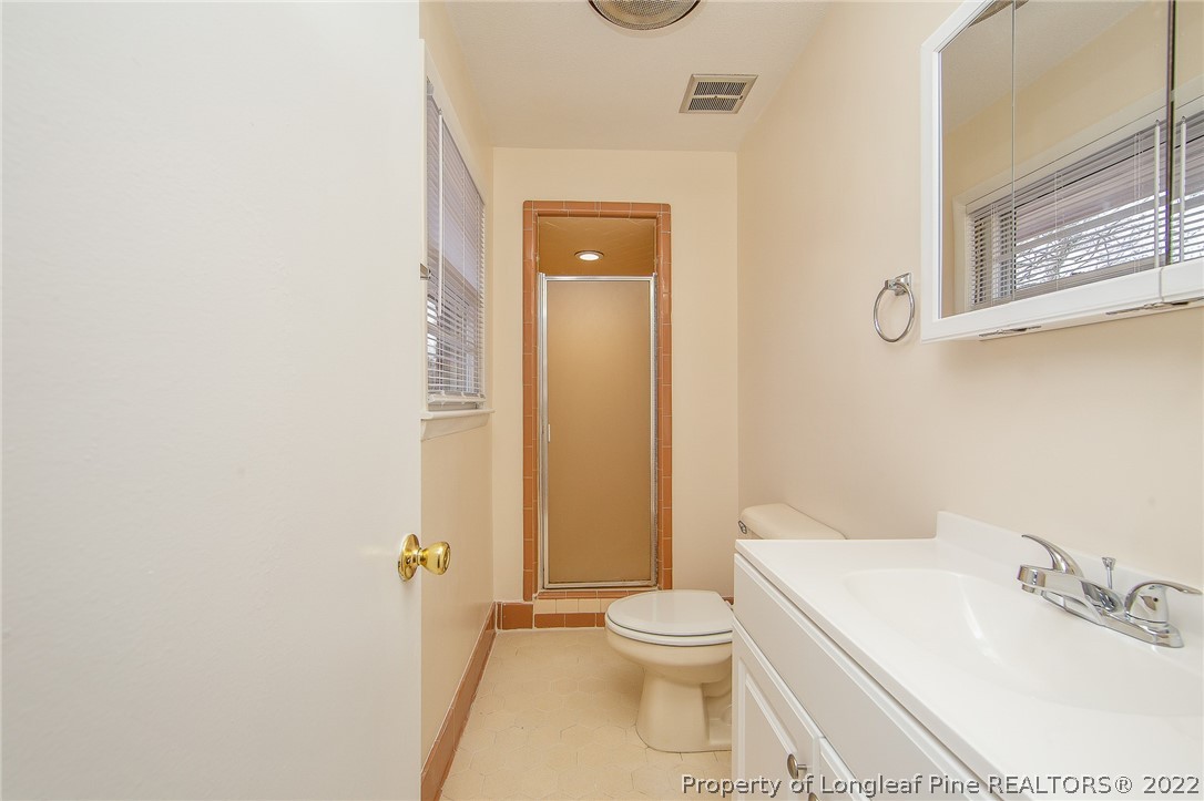660 Pleasant Loop Fayetteville, NC 28311 - Photo 19 of 35 a white toilet sitting next to a bathroom sink