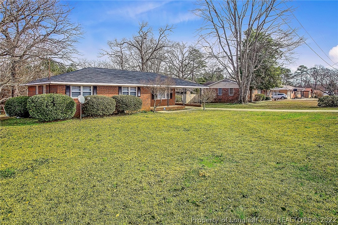 660 Pleasant Loop Fayetteville, NC 28311 - Photo 2 of 35 a front view of a house with yard and green space