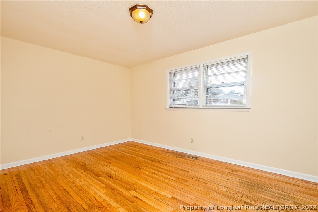660 Pleasant Loop Fayetteville, NC 28311 - Photo 22 of 35 a view of empty room with wooden floor