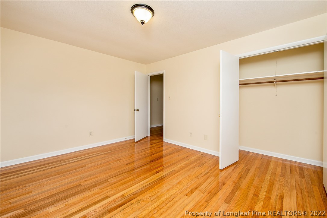 660 Pleasant Loop Fayetteville, NC 28311 - Photo 26 of 35 an empty room with wooden floor and a window
