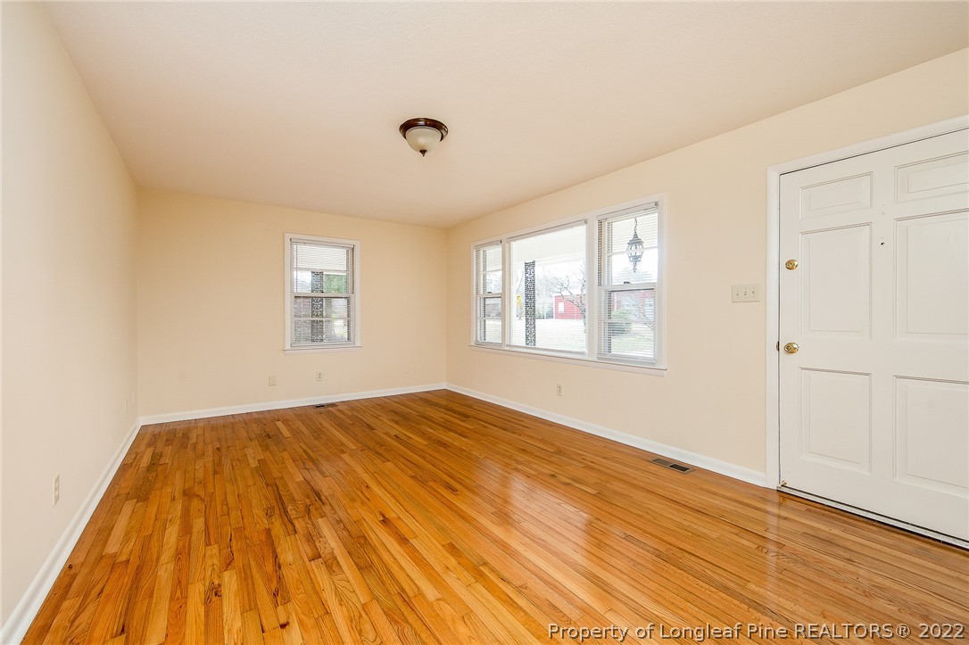660 Pleasant Loop Fayetteville, NC 28311 - Photo 5 of 35 a view of empty room with wooden floor and fan