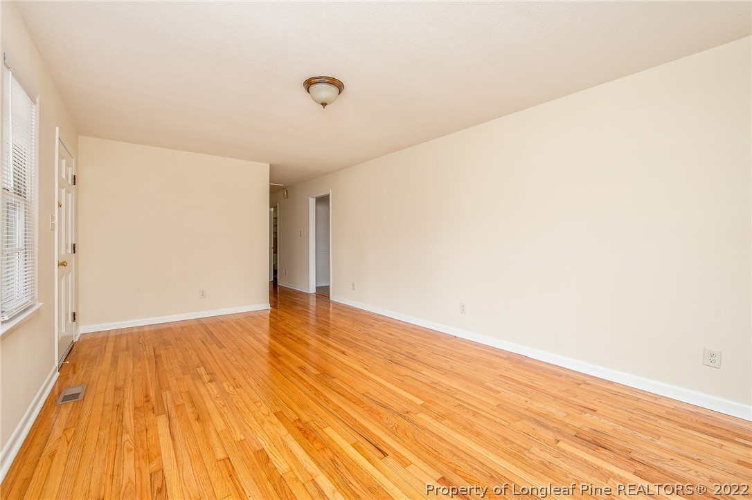 660 Pleasant Loop Fayetteville, NC 28311 - Photo 8 of 35 a view of an empty room with wooden floor