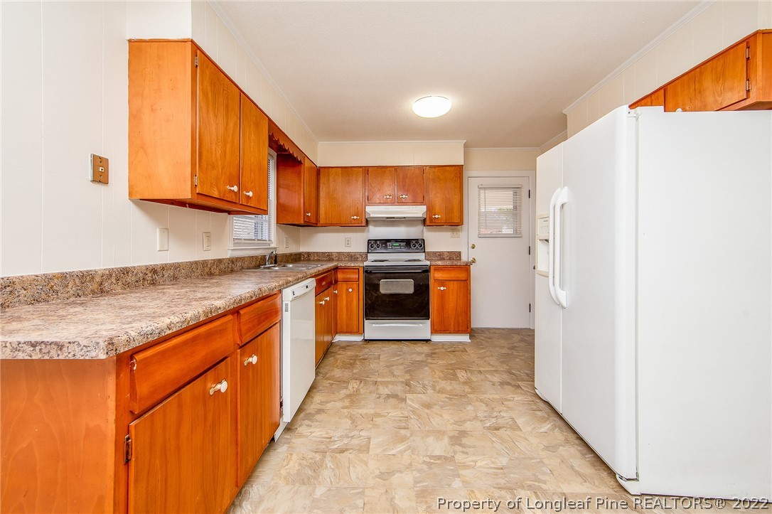 660 Pleasant Loop Fayetteville, NC 28311 - Photo 10 of 35 a kitchen with stainless steel appliances granite countertop a refrigerator a stove and a sink