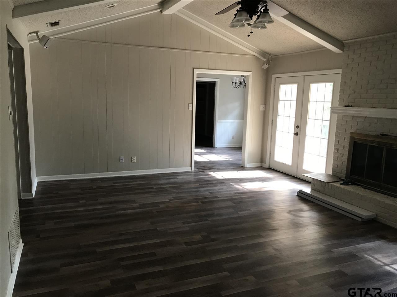 8233 Clemson Drive Tyler, TX 75703 - Photo 5 of 6 a view of a livingroom with wooden floor and a ceiling fan