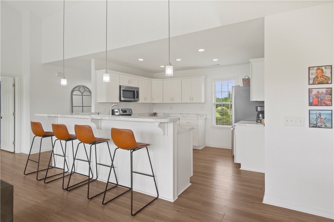 2900 Highway 187 Anderson, SC 29626 - Photo 11 of 41 A well-lit kitchen with white cabinetry and a convenient breakfast bar for casual dining.