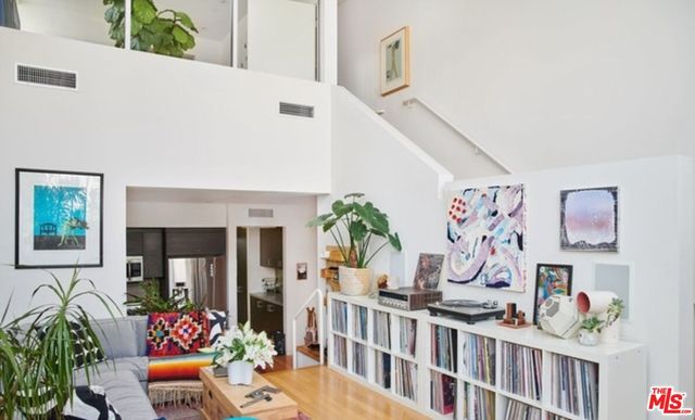 a living room with furniture and flowers