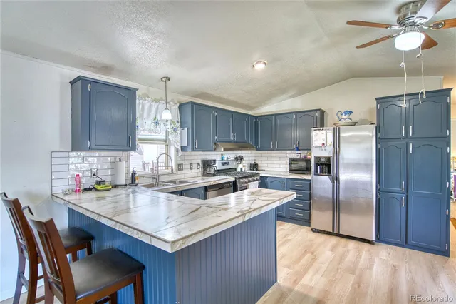 a kitchen with sink cabinets and stainless steel appliances