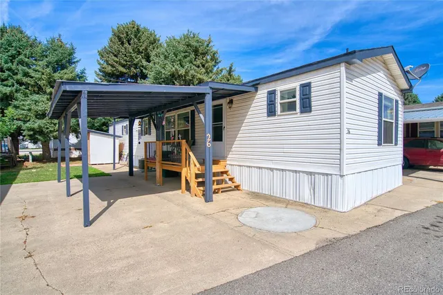 a view of a house with a patio and a yard
