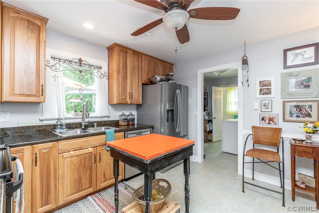 11231 Celtic Road Chesterfield, VA 23838 - Photo 11 of 26 a kitchen with stainless steel appliances granite countertop a refrigerator a sink dishwasher a dining table and chairs with wooden floor
