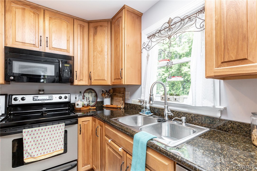 11231 Celtic Road Chesterfield, VA 23838 - Photo 12 of 26 a kitchen with a stove a sink and a microwave