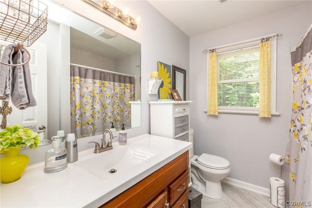 11231 Celtic Road Chesterfield, VA 23838 - Photo 16 of 26 a bathroom with a sink a toilet and a window