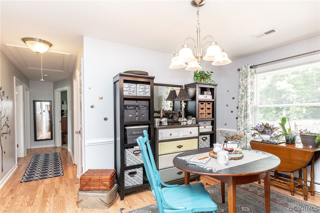 11231 Celtic Road Chesterfield, VA 23838 - Photo 8 of 26 a view of a dining room with furniture wooden floor and chandelier