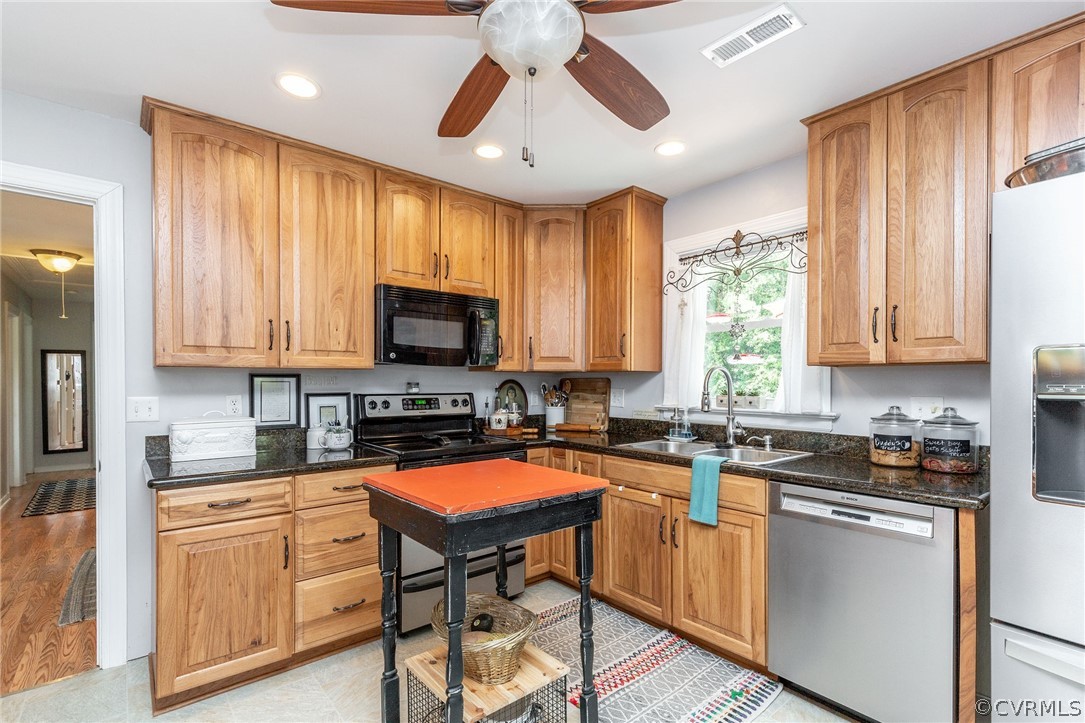11231 Celtic Road Chesterfield, VA 23838 - Photo 10 of 26 a kitchen with stainless steel appliances granite countertop a stove a sink dishwasher and a microwave oven with cabinets