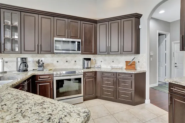 a dining room with furniture windows and a potted plant