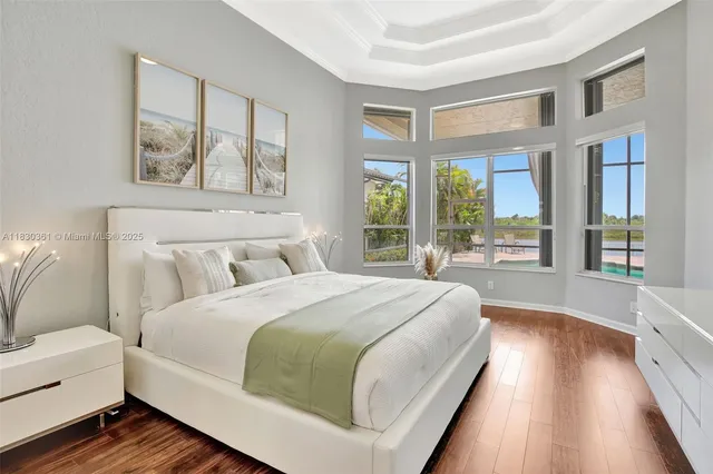 a bedroom with a bed and a painting on the wall