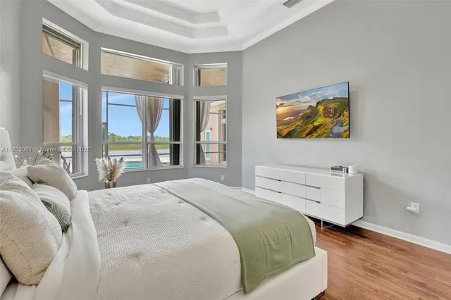 a bedroom with a bed and a flat screen tv