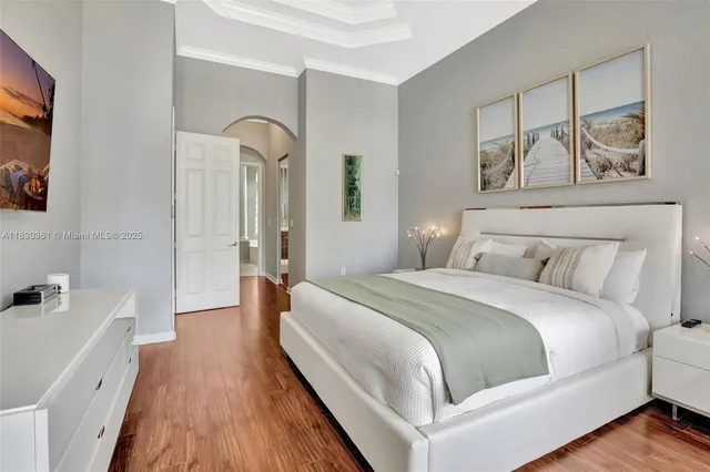 a spacious bathroom with a granite countertop double vanity sink a mirror and a