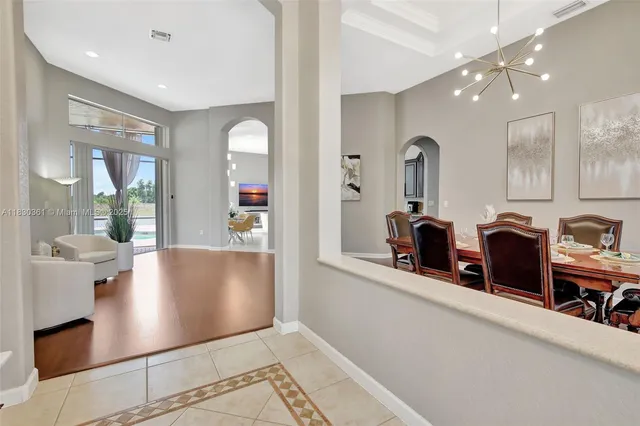 a dining room with furniture and wooden floor