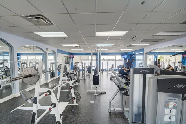 a view of a swimming pool with a table and chairs under an umbrella