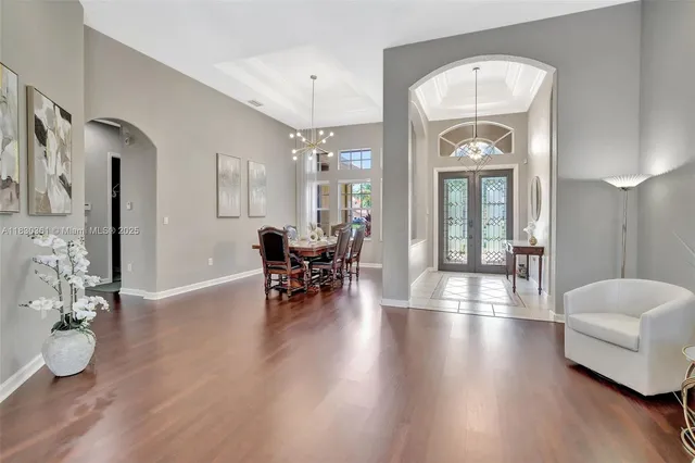 a view of a livingroom with wooden floor and furniture