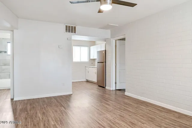 a view of a kitchen with a sink and a refrigerator