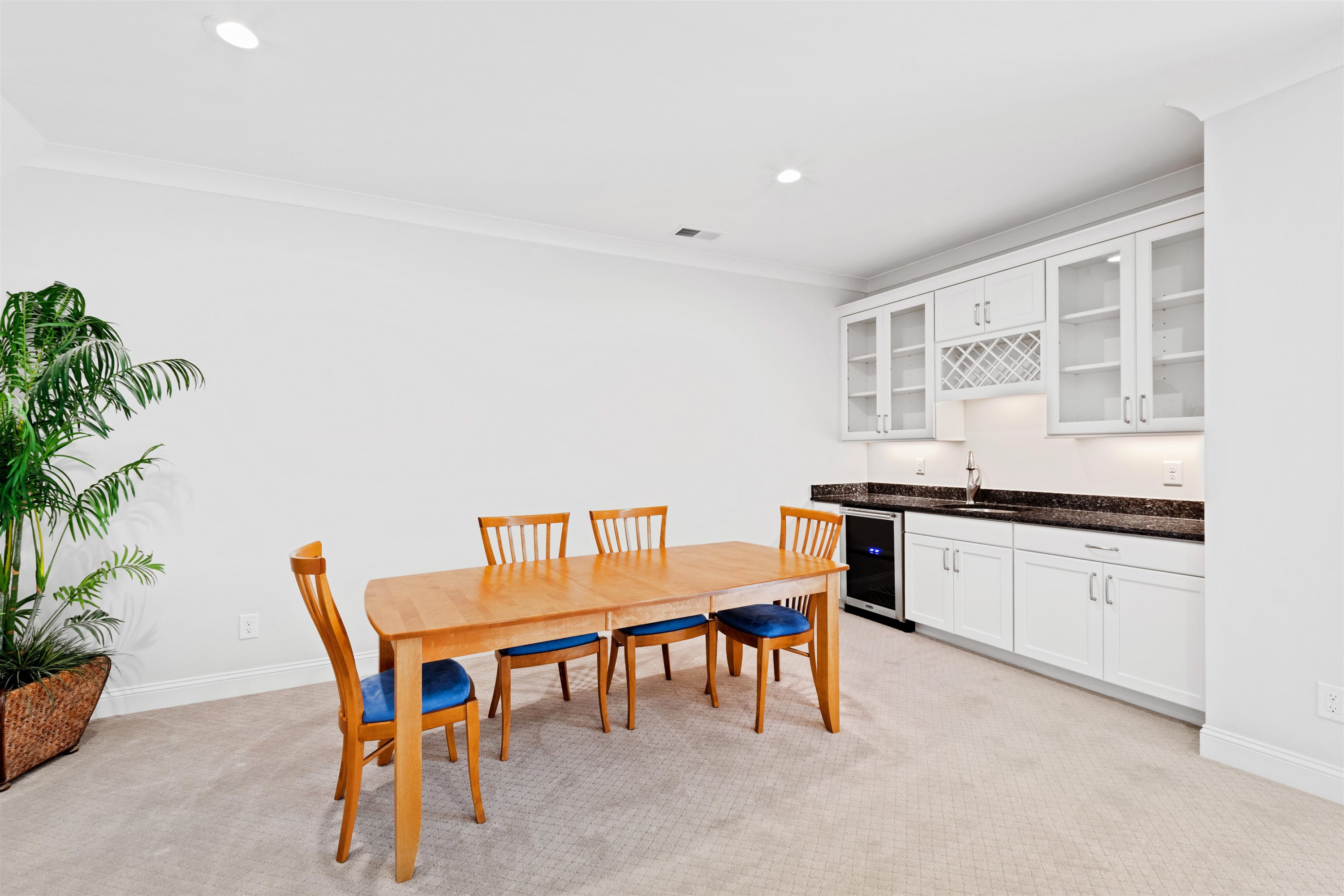 10340 Grafton Road Raleigh, NC 27615 - Photo 44 of 70 a kitchen with stainless steel appliances granite countertop a table and chairs in it