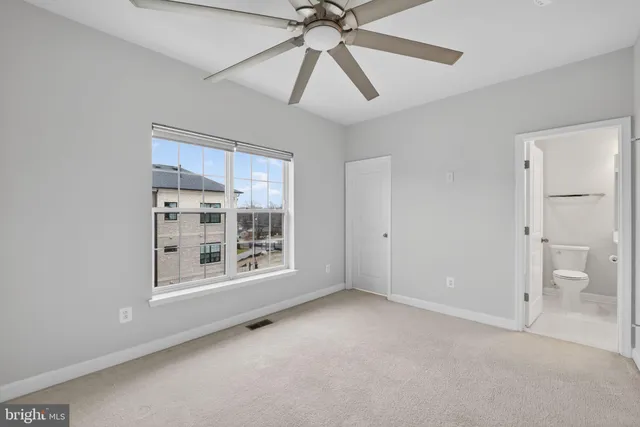 a view of a kitchen with wooden floor and electronic appliances