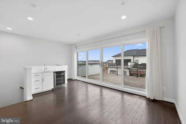 a view of a livingroom with an empty space and a window