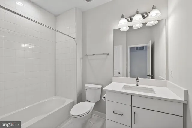 a roof deck with table and chairs