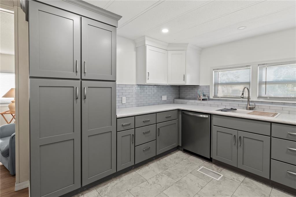 4902 91st Lane North St. Petersburg, FL 33708 - Photo 12 of 41 a kitchen with a refrigerator sink and cabinets