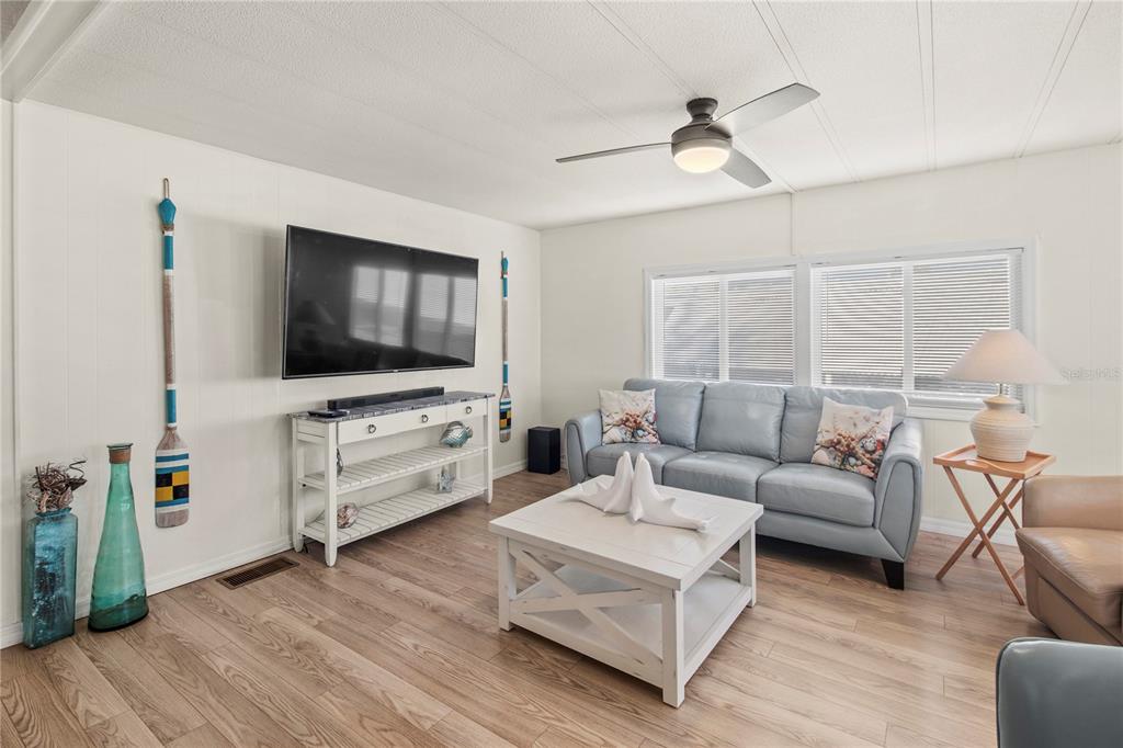 4902 91st Lane North St. Petersburg, FL 33708 - Photo 14 of 41 a living room with furniture and a flat screen tv