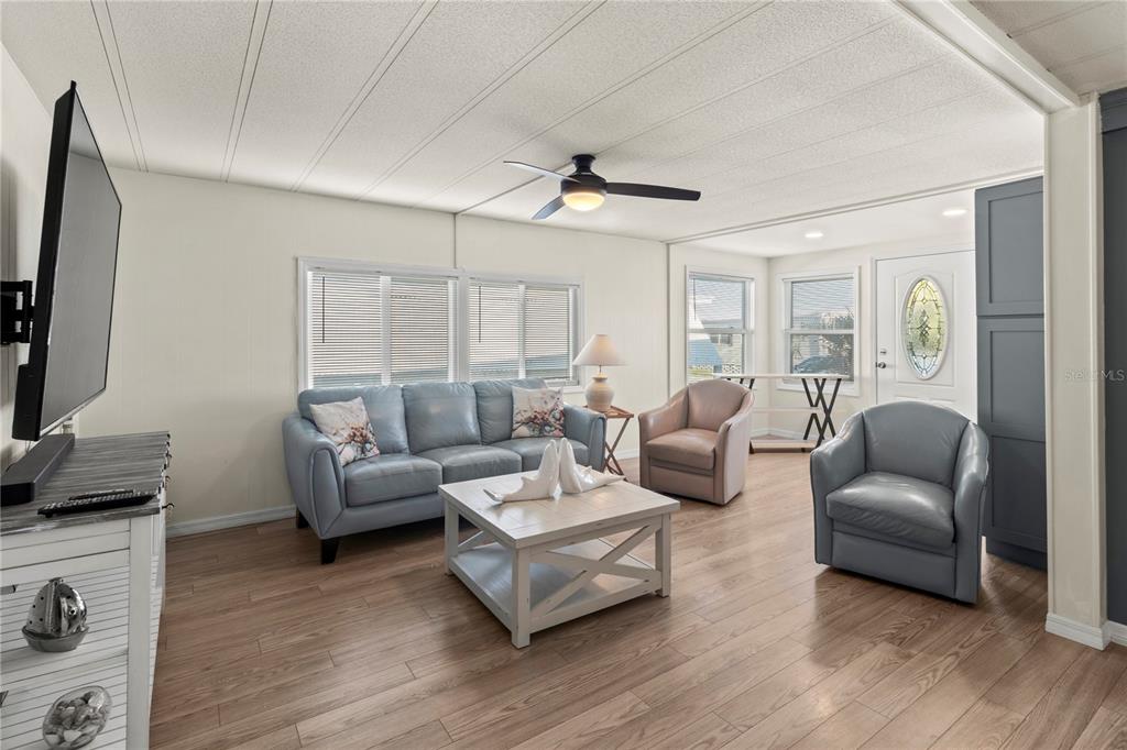 4902 91st Lane North St. Petersburg, FL 33708 - Photo 15 of 41 a living room with furniture and a flat screen tv