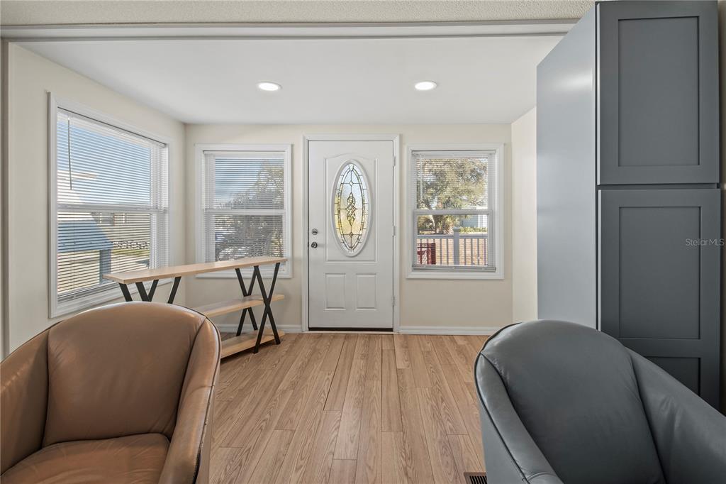 4902 91st Lane North St. Petersburg, FL 33708 - Photo 16 of 41 a living room with furniture and a large window