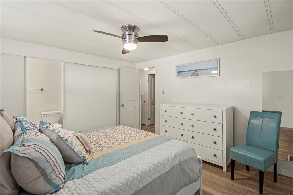 4902 91st Lane North St. Petersburg, FL 33708 - Photo 22 of 41 a bedroom with a bed and furniture