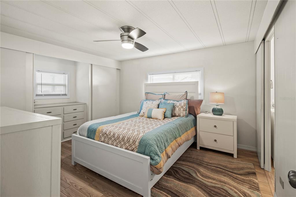 4902 91st Lane North St. Petersburg, FL 33708 - Photo 23 of 41 a room with a bed and a chandelier