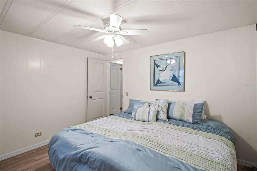 4902 91st Lane North St. Petersburg, FL 33708 - Photo 28 of 41 a bedroom with a bed and a painting on the wall