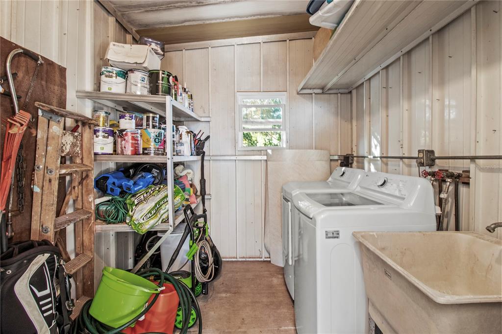 4902 91st Lane North St. Petersburg, FL 33708 - Photo 30 of 41 a utility room with stainless steel appliances furniture a washer and dryer