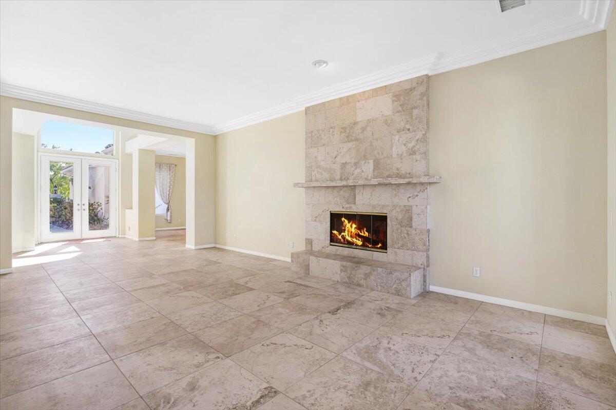 3 Trafalgar Rancho Mirage, CA 92270 - Photo 11 of 26 an empty room with a fireplace and windows