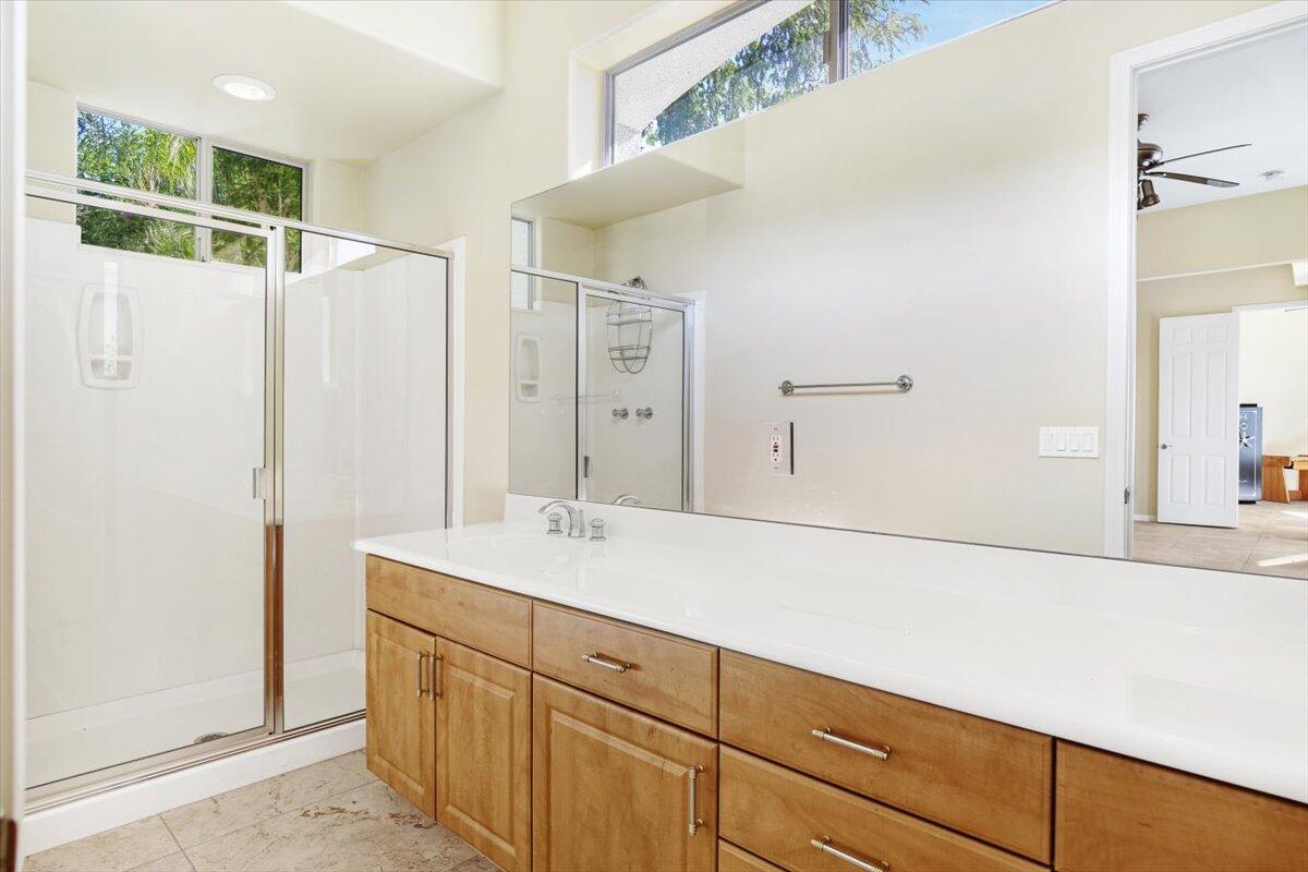 3 Trafalgar Rancho Mirage, CA 92270 - Photo 20 of 26 a bathroom with a shower sink and mirror