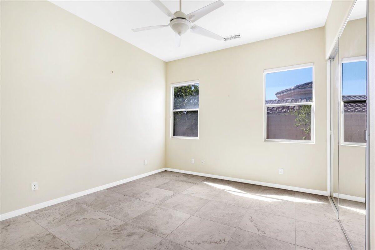 3 Trafalgar Rancho Mirage, CA 92270 - Photo 23 of 26 an empty room with a ceiling fan and carpet