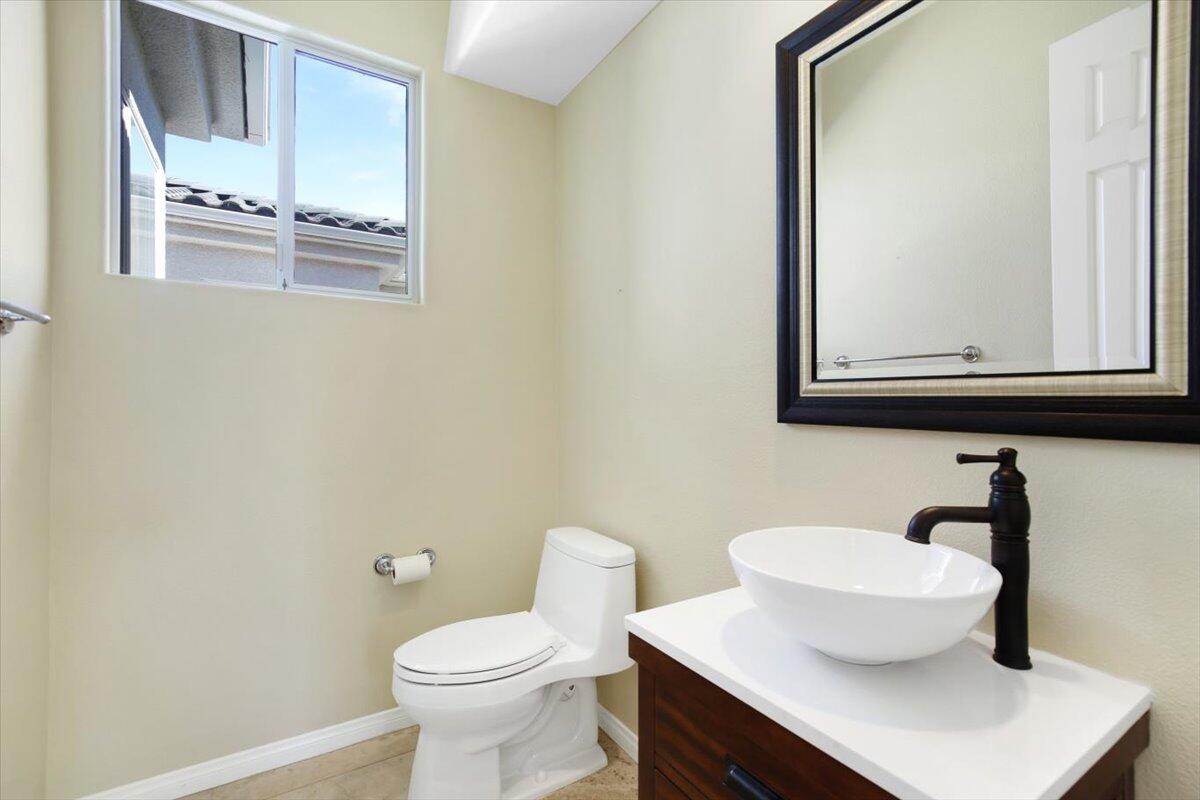 3 Trafalgar Rancho Mirage, CA 92270 - Photo 24 of 26 a bathroom with a toilet a sink and mirror