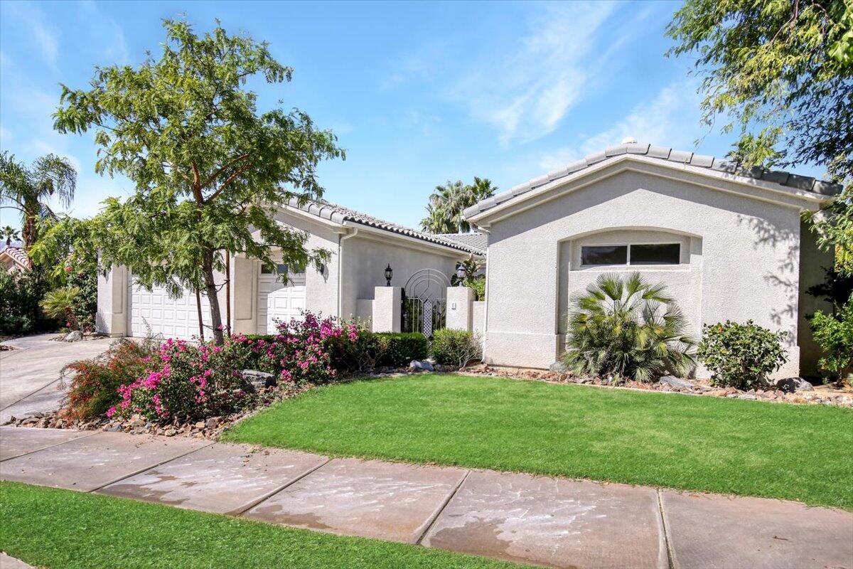 3 Trafalgar Rancho Mirage, CA 92270 - Photo 6 of 26 a front view of a house with a garden